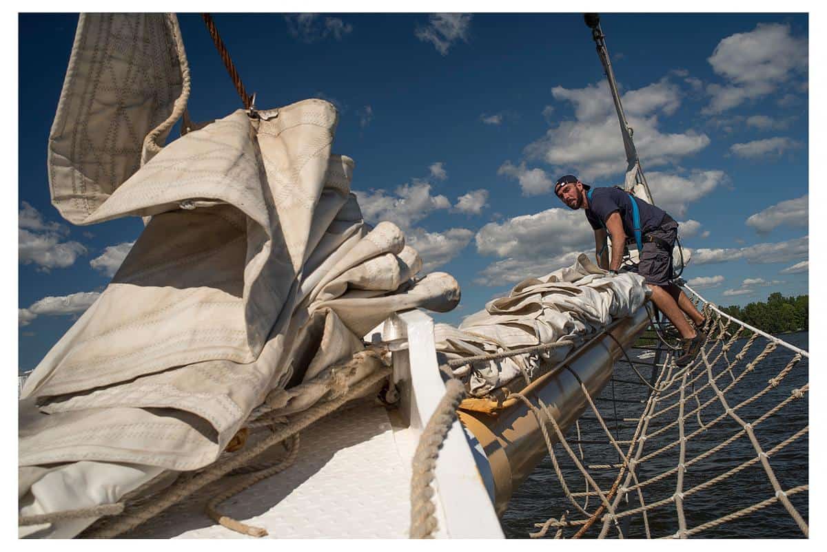 flaking the headsails on the bowsprit
