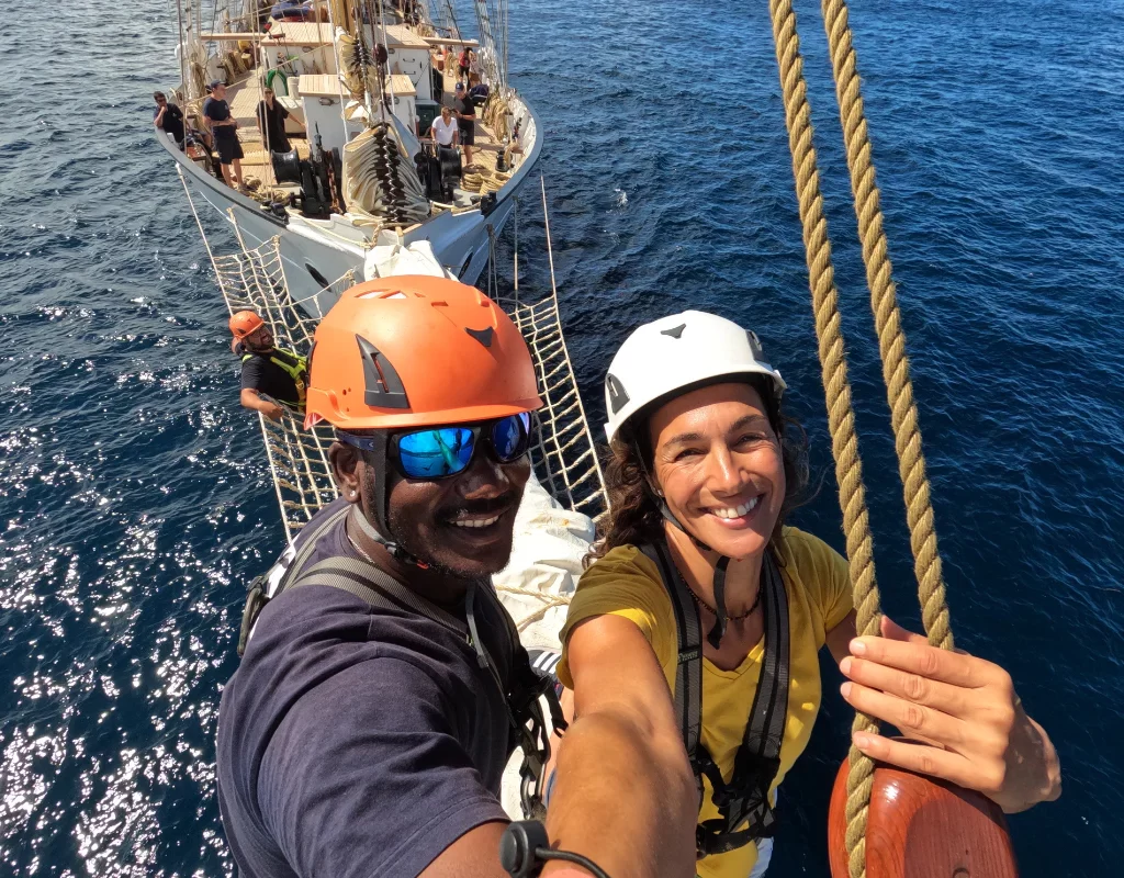 Santa Maria Manuela crew out on the bowsprit. experience a relaxed sailing adventure holiday aboard santa maria manuela with classic sailing.