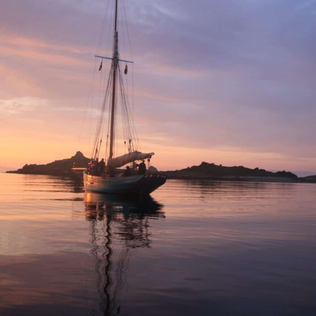 Ocean sunset after a long midsummer day in the isles of scilly on sailing boat Tallulah