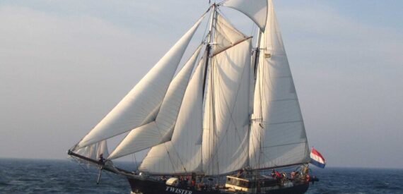 Schooner Twister under full sail in golden light